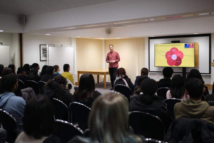 6019-1400 Student Recruitment and Progression manager speaking to school students at Unlock Oxford Residential programme 2023.