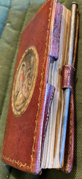 Binding and title page of le secretaire des dames -cover Binding and title page of 'Le Secrétaire des Dames' held in the Bibliothèque de l'Arsenal with a metal stylus that, with three leather loops, acts as a closure for the volume