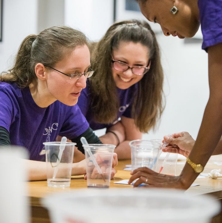 Chemistry Students demonstrating an experiment at the College's Research Expo