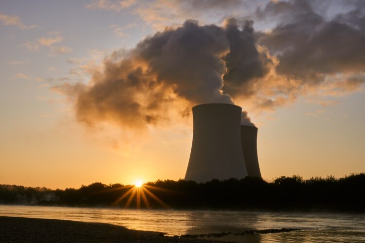 An image of a cooling tower at sunset