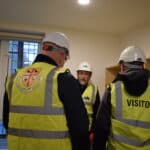 Members of the St Edmund Hall Governing Body inspecting a model bedroom at Norham St Edmund