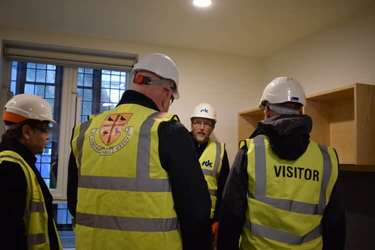 Members of the St Edmund Hall Governing Body inspecting a model bedroom at Norham St Edmund