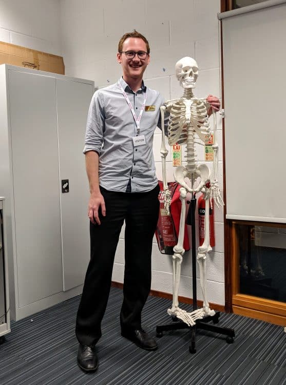 Schools Liaison Officer Luke Maw with a model skeleton who observed his talk at WQE college in Leicester Schools Liaison Officer Luke Maw with a model skeleton who observed his talk at WQE college in Leicester